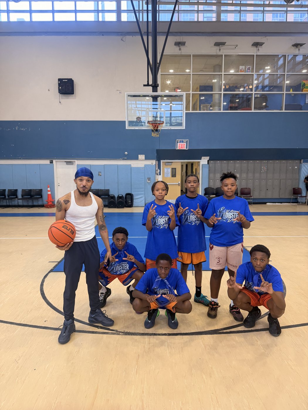Youth team in blue jerseys on an indoor court
