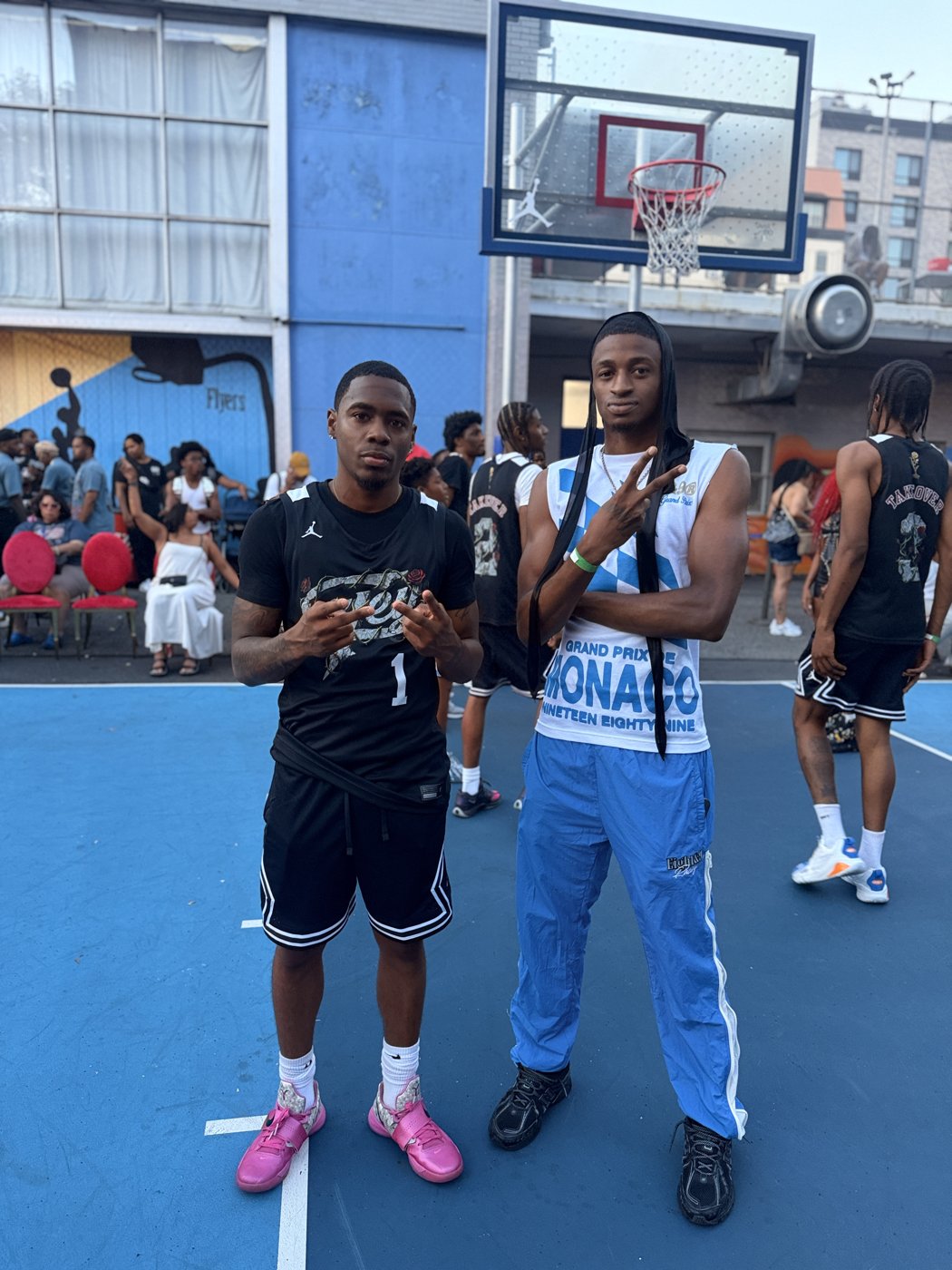 Two players on a blue outdoor court